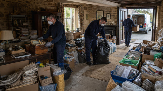 Clearing a heavily cluttered room during a hoarded property clearance